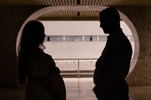 silhouette of an expecting couple 