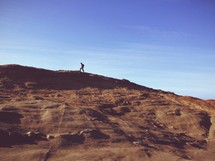 Person hiking atop a mountain.