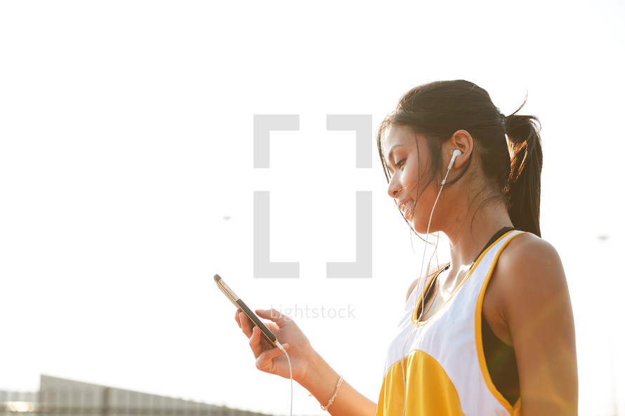 a woman listening to music as she trains 