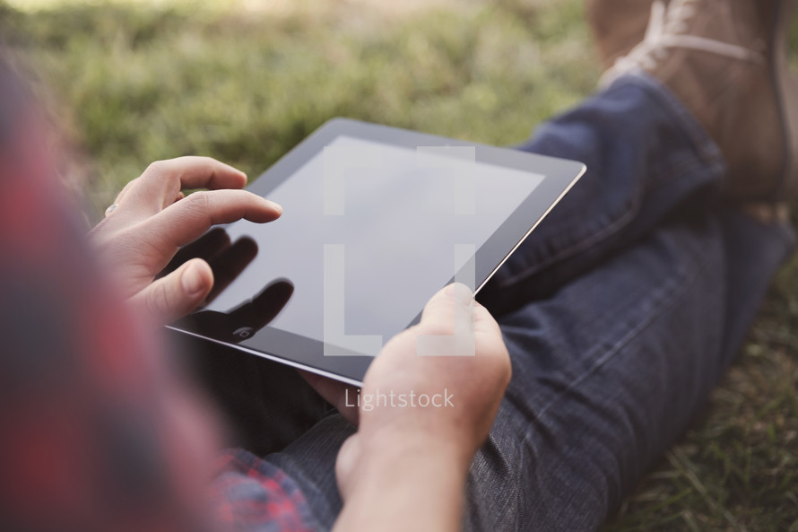 a man sitting with an iPad 