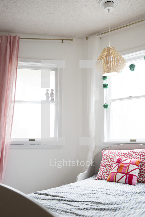 lamp hanging over a twin bed