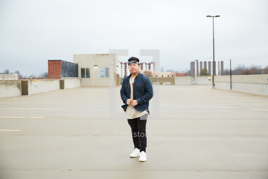 a young man standing on a parking deck 