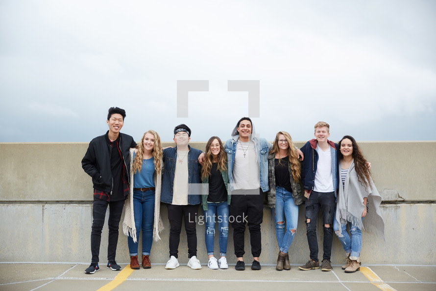 group of teens standing in a row
