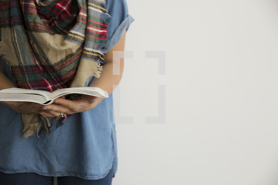 a torso of a woman reading a Bible, fall Bible study 
