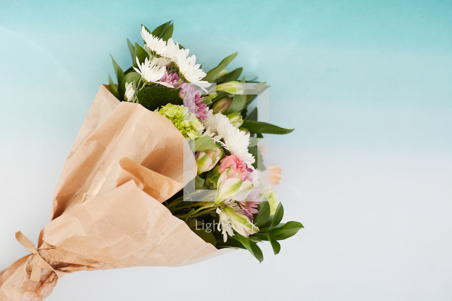 bouquet of flowers in brown paper 