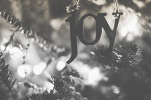 A joy ornament on the Christmas tree