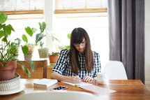 a woman sitting at a desk journaling 