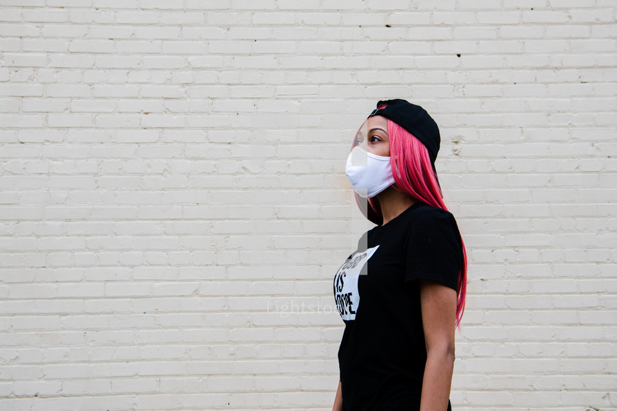 a portrait of a young African American woman in a face mask with copy space 
