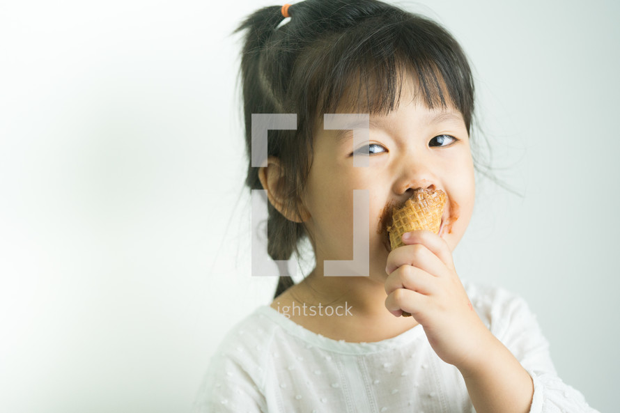 child eating an ice cream cone 