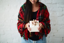 a woman holding a gift box 