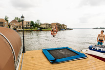 a man doing a flip off a dock 