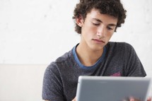 a teen boy on a tablet 