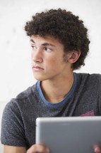 a teen boy using a tablet 