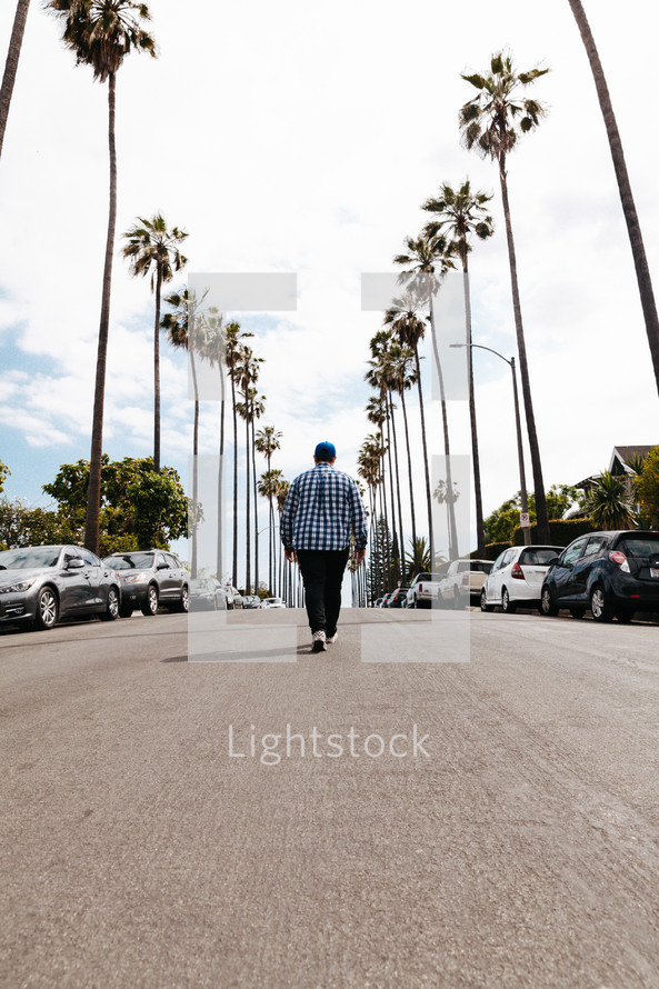 a man walking down the middle of a street 