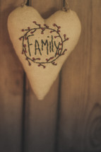 Family written on a heart shaped pillow 