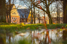 a puddle in grass and view of row houses 