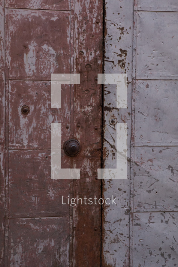 doorbell on a rusty metal door 
