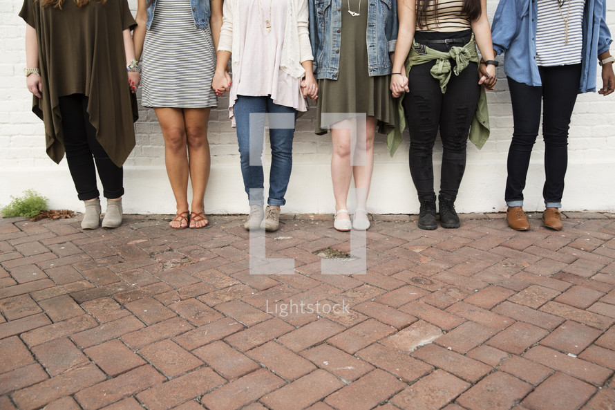 Legs of a group of female friends. 