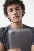 teen boy checking his cellphone 