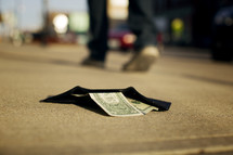 a lost wallet on a sidewalk 