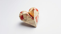 A small origami heart made up of old paper. 