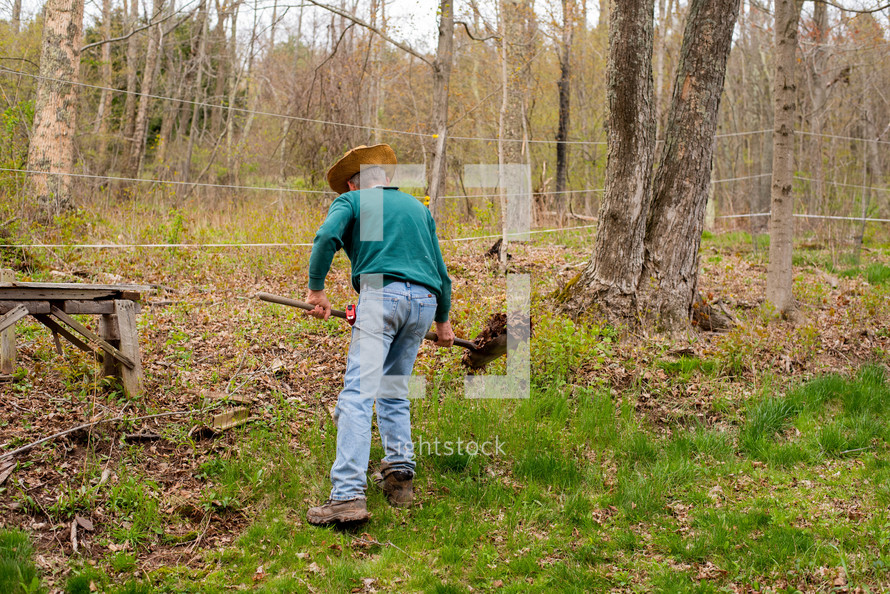 a man shoveling dirt 