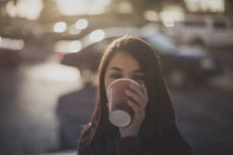 A woman drinking a cup of coffee