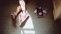 feet in sneakers and magazines 