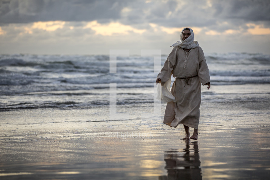 Jesus walking on a beach 
