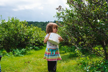 girl picking blueberries 