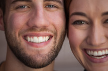 closeup of the faces of a happy couple 