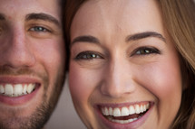 closeup of the faces of a happy couple 