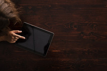 woman touching an iPad screen 