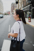 a woman crossing a street 