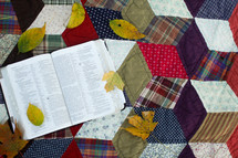 a Bible on a quilt 
