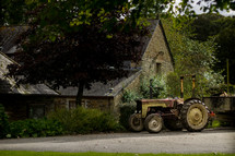 tractor in front of a rural home 