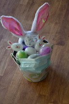 Easter basket filled with Easter eggs and a face mask 