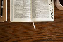 journal, pen, open Bible, and coffee mug