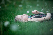 a girl lying in the grass