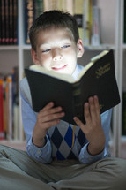 boy reading the Holy Bible