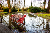 park bench in a puddle 