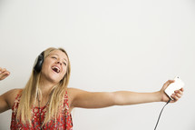 teen girl dancing and singing to music.