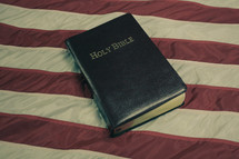 Holy Bible on American flag with retro effect.