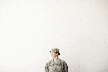 Female army soldier looking away. 