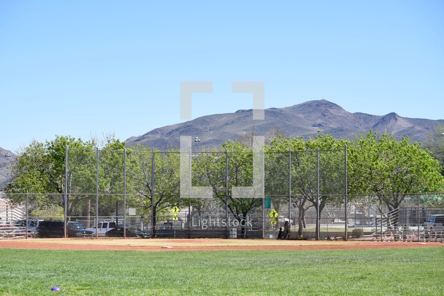 mountain behind a baseball field at a park 