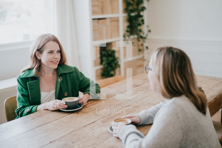 women sitting together having coffee 