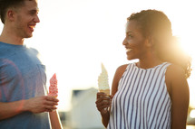 a couple eating ice cream cones 