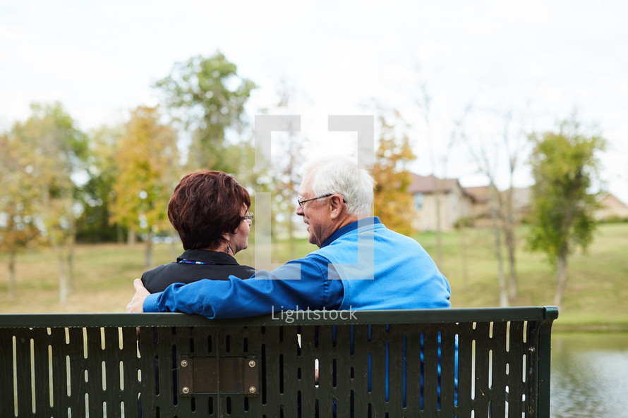 elderly couple on a park bench 