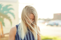 blonde woman with hair blowing in the breeze