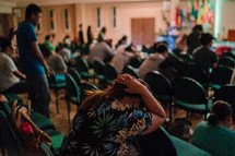 a woman crying during a worship service 